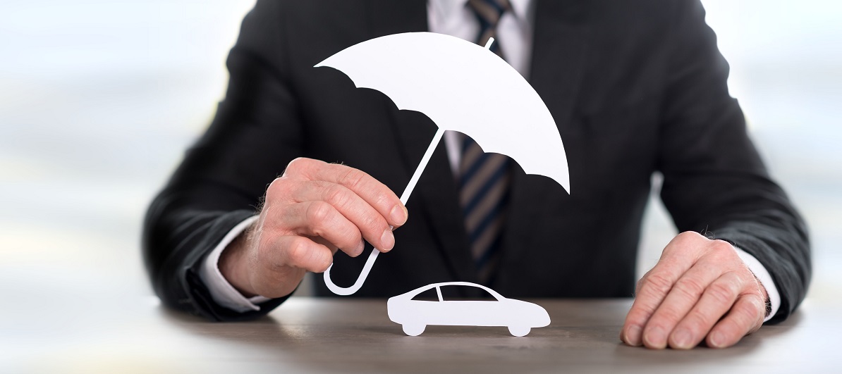Businessman holding umbrella over car cutout