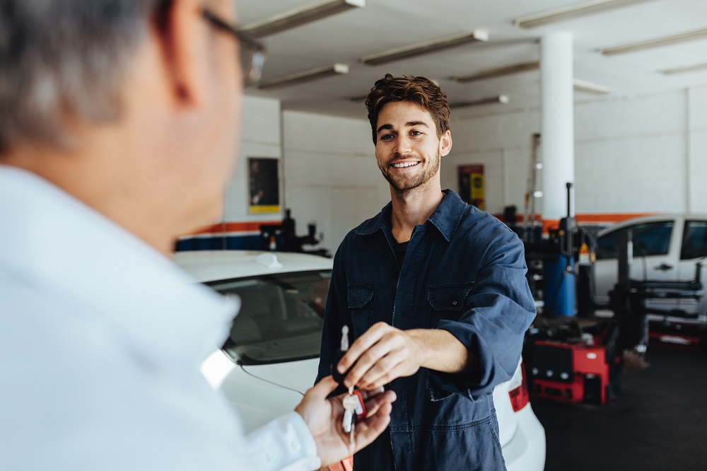 Mechanic giving keys back to customer
